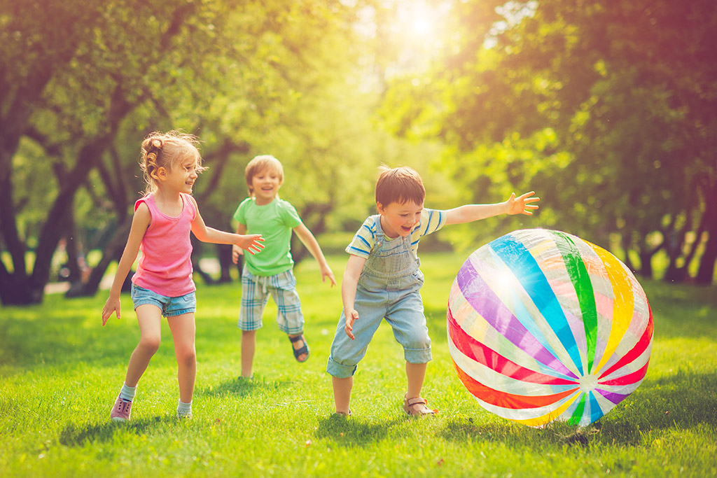 Little-girl-and-boys-playing-with-ball