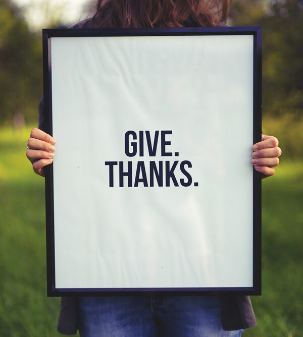 Photo of woman holding frame prompting to give thanks