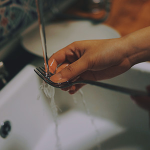 Photo of person washing a fork
