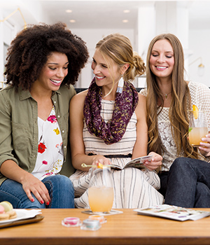 women conversing over fragrances at a Scentsy party