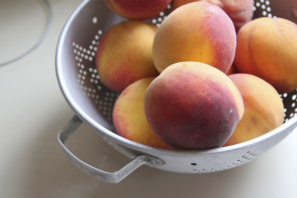 photo of fresh peaches in a colander