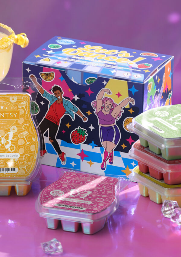 The Scentsy Let's Dance Wax Collection box and corresponding wax bars are displayed on a purple tabletop surrounded by confetti, fruity cocktail drinks, and party decorations.