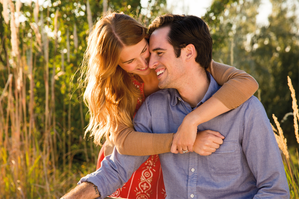 Happy engaged couple enjoying the outdoor sunshine