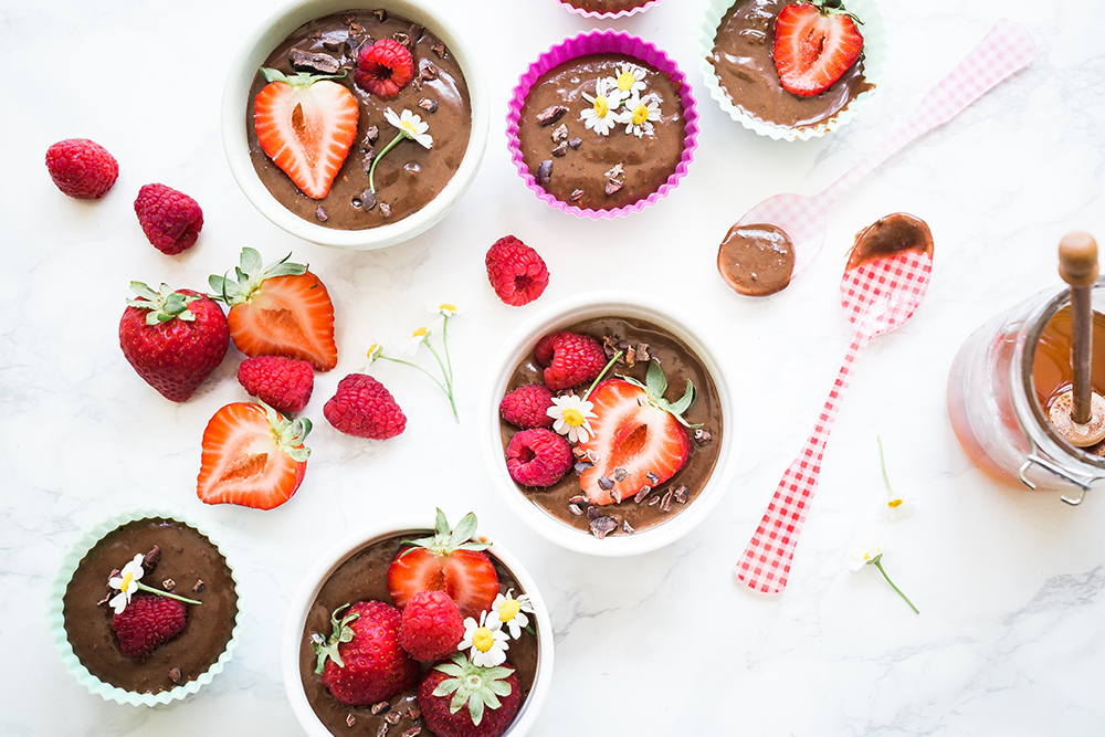Above photo of chocolate pudding cups with flowers and berries