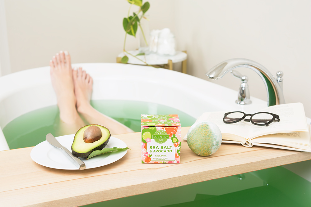 Photo of woman relaxing in bath with a Sea Salt and Avacado Scentsy Bath Bomb