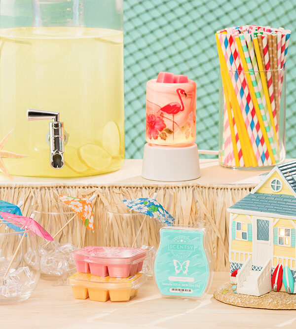 Photo of the scentsy's summer collection products in a beach party scene