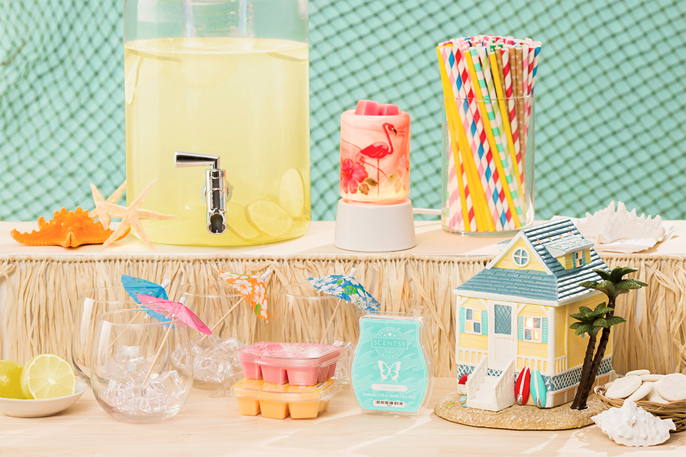 Photo of the scentsy's summer collection products in a beach party scene