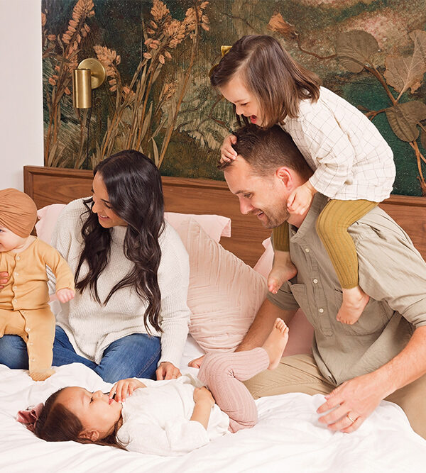 Photo of family playing on bed