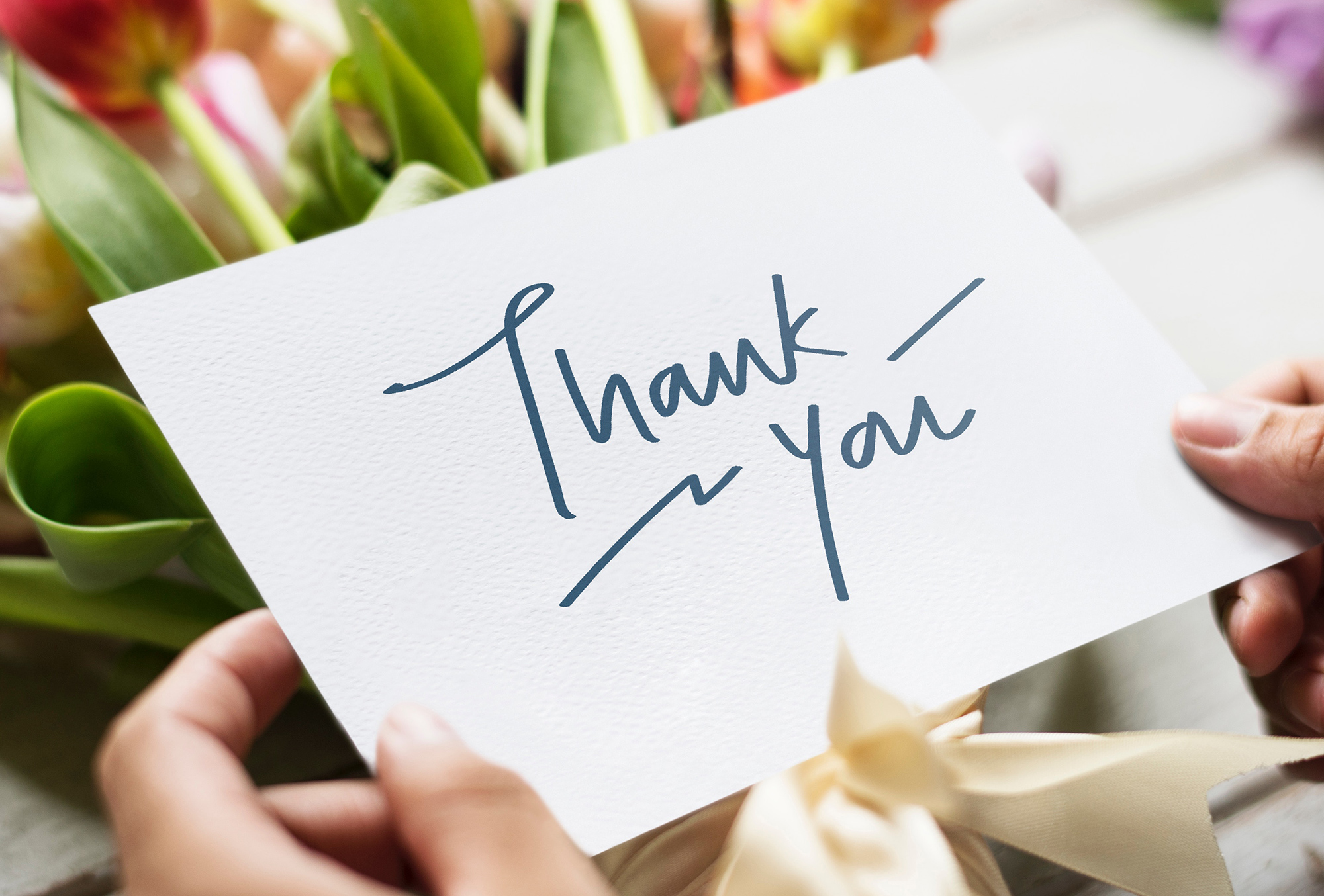 woman holding open a thank you card