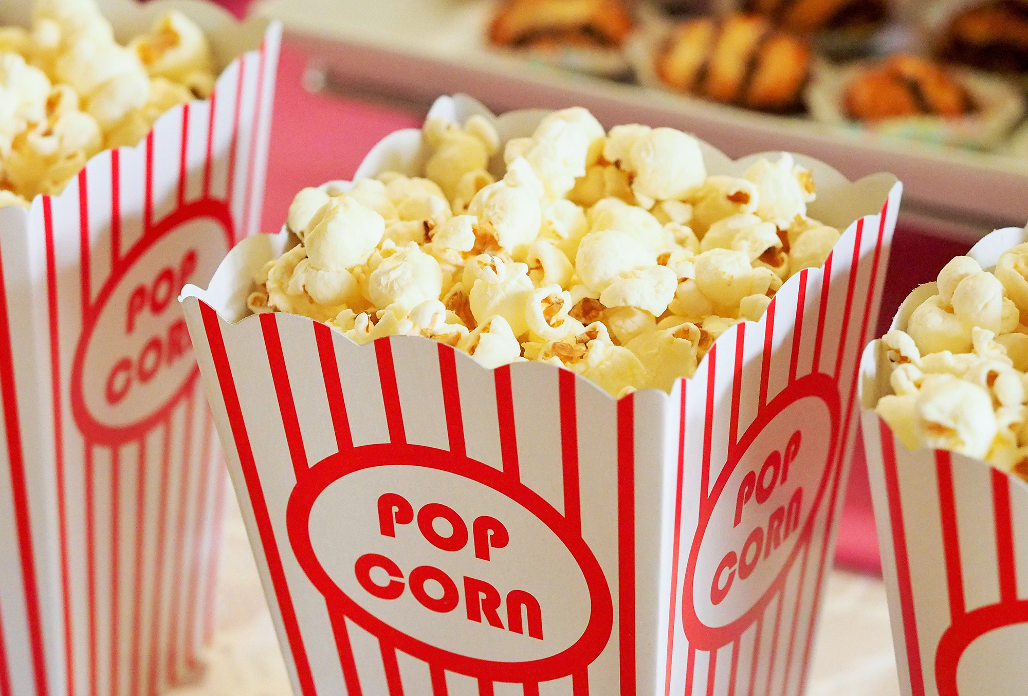 Photo of popcorn and treats atop a table ready for movie night