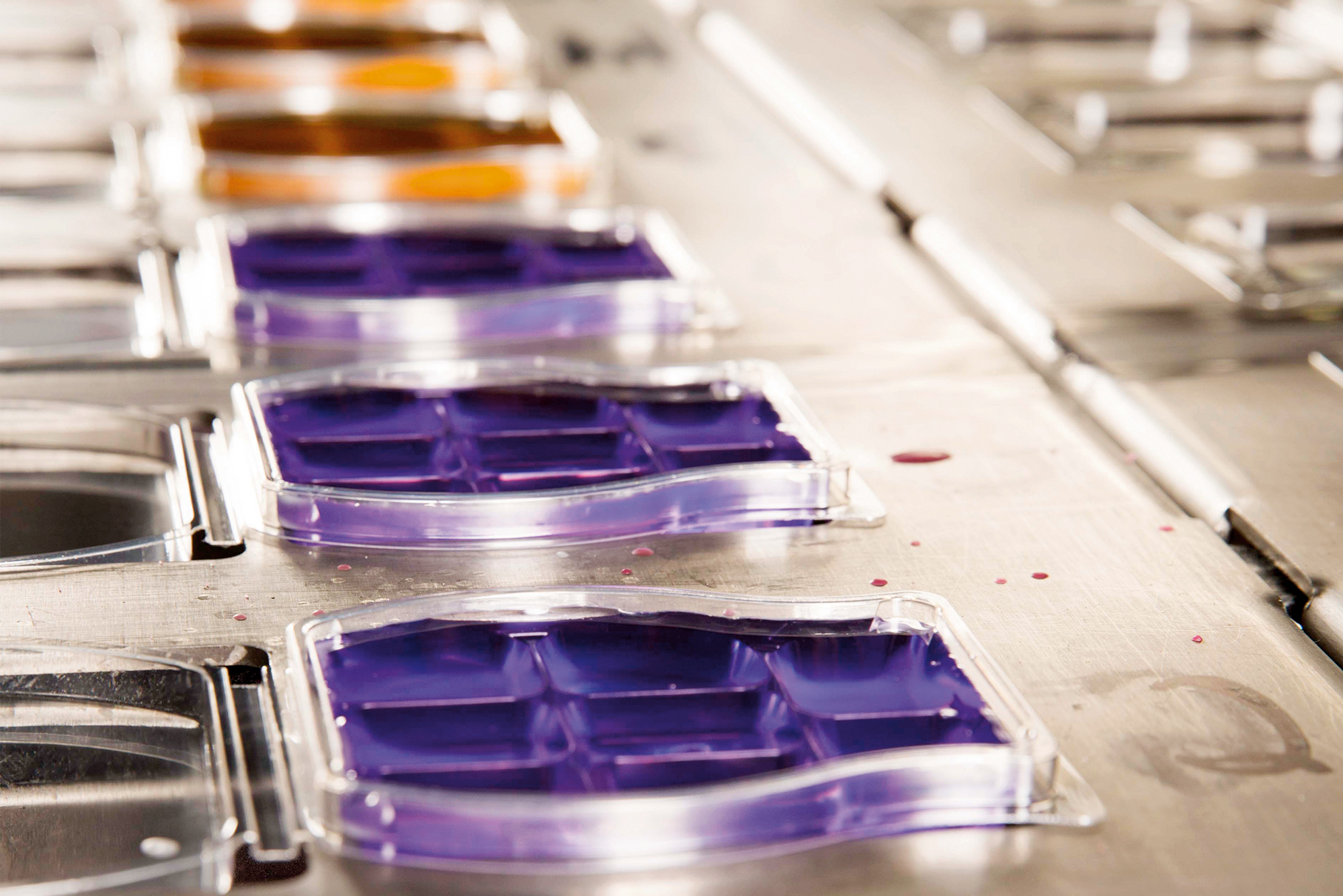 scentsy wax bars being poured in a manufacturing setting 