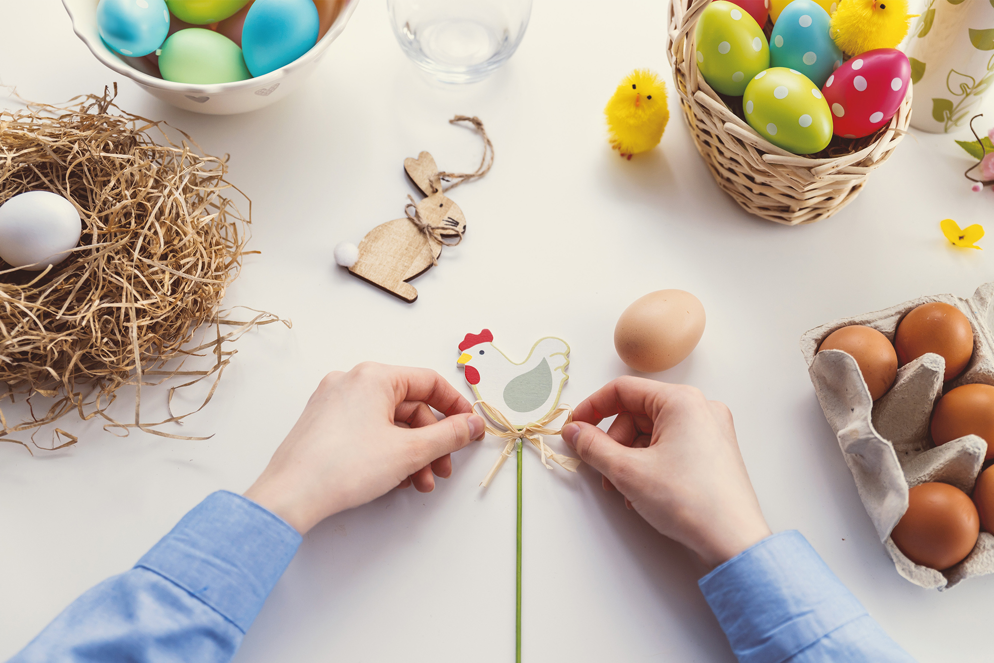 woman preparing easter eggs and easter decorations