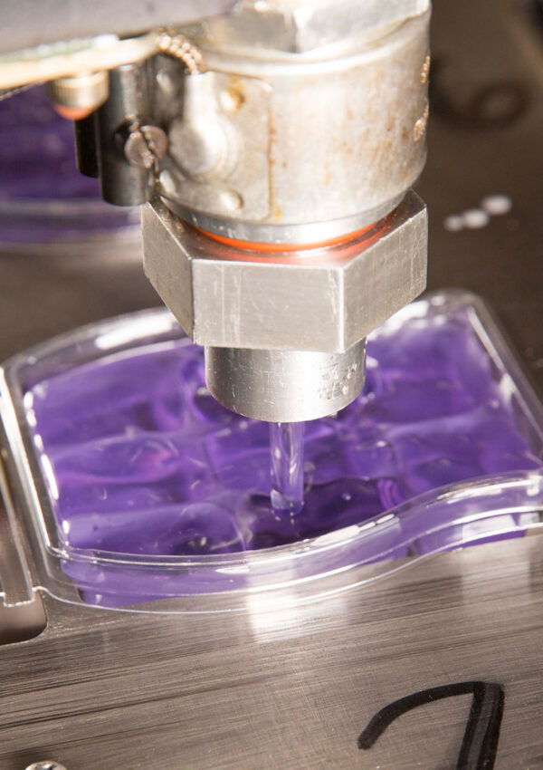 Scentsy wax bar being filled with wax on factory belt