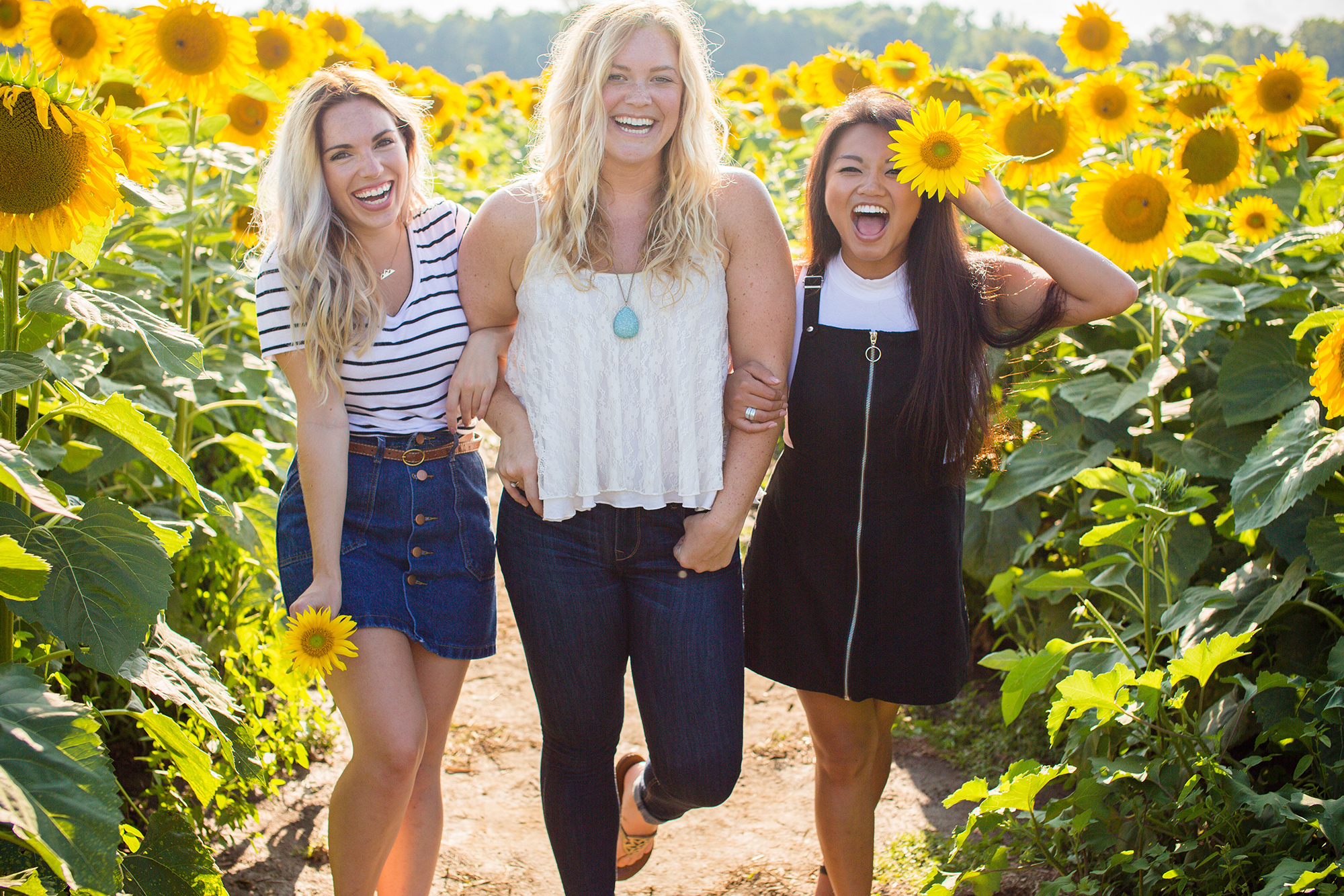 Friends laughing in field of flowers