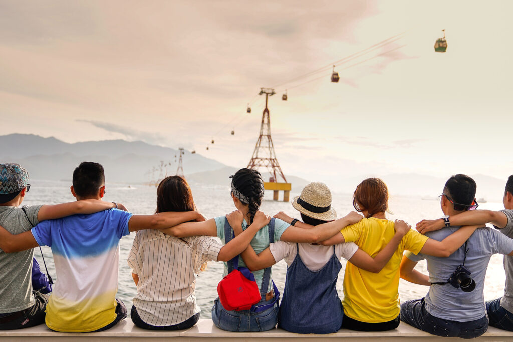 Group of friends watching sky trams move across the sky