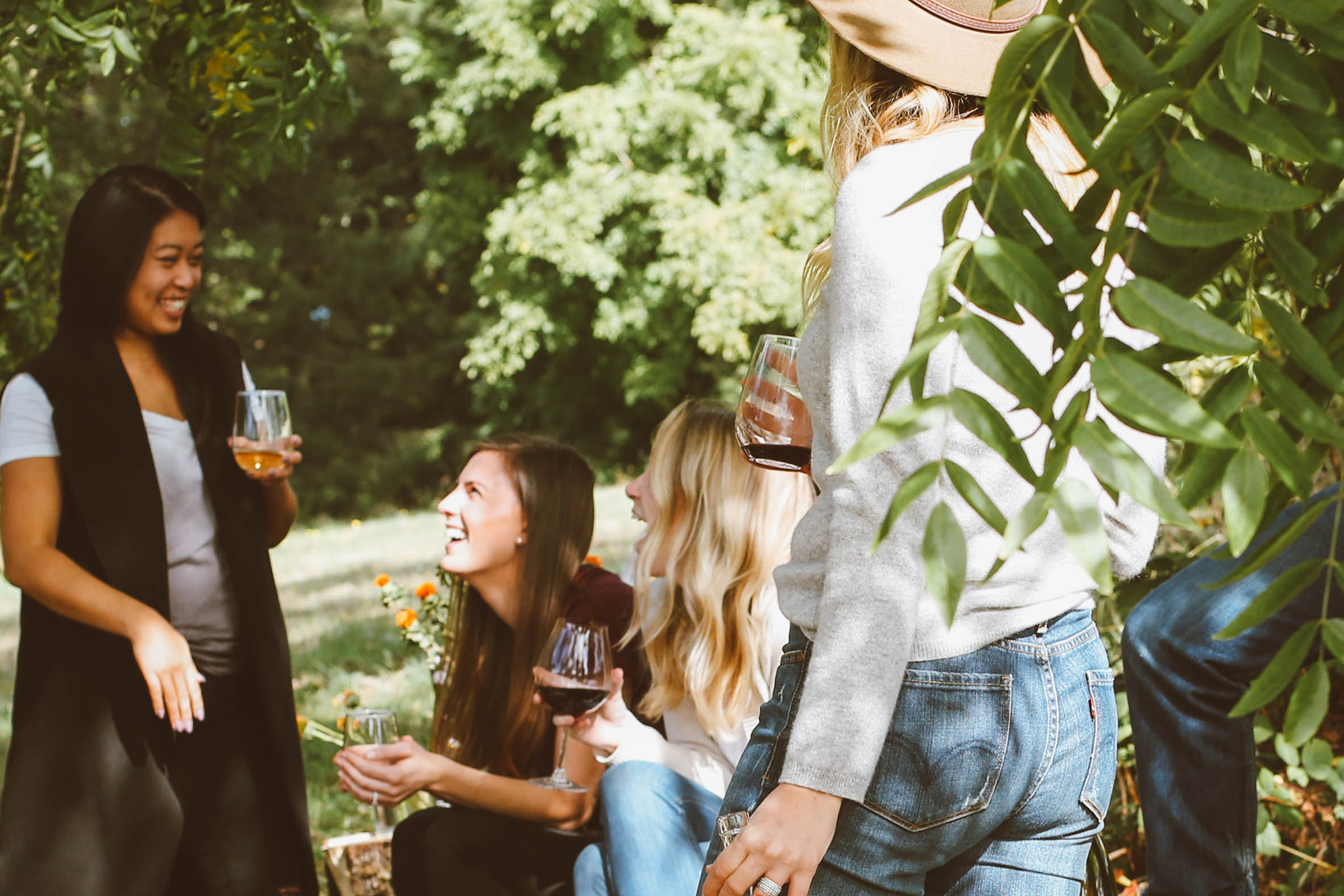 group of women outside drinking and laughing