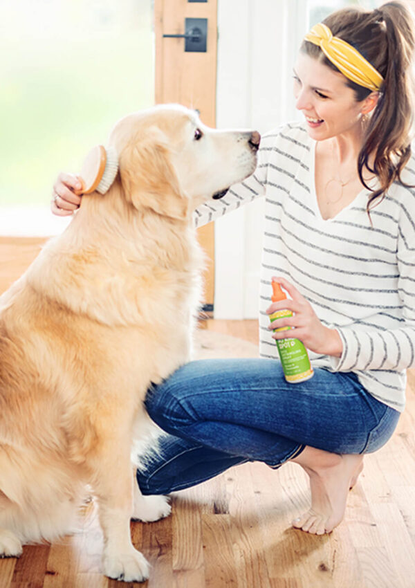 Woman using Oatmeal & Aloe Scentsy Pets product on her golden retriever