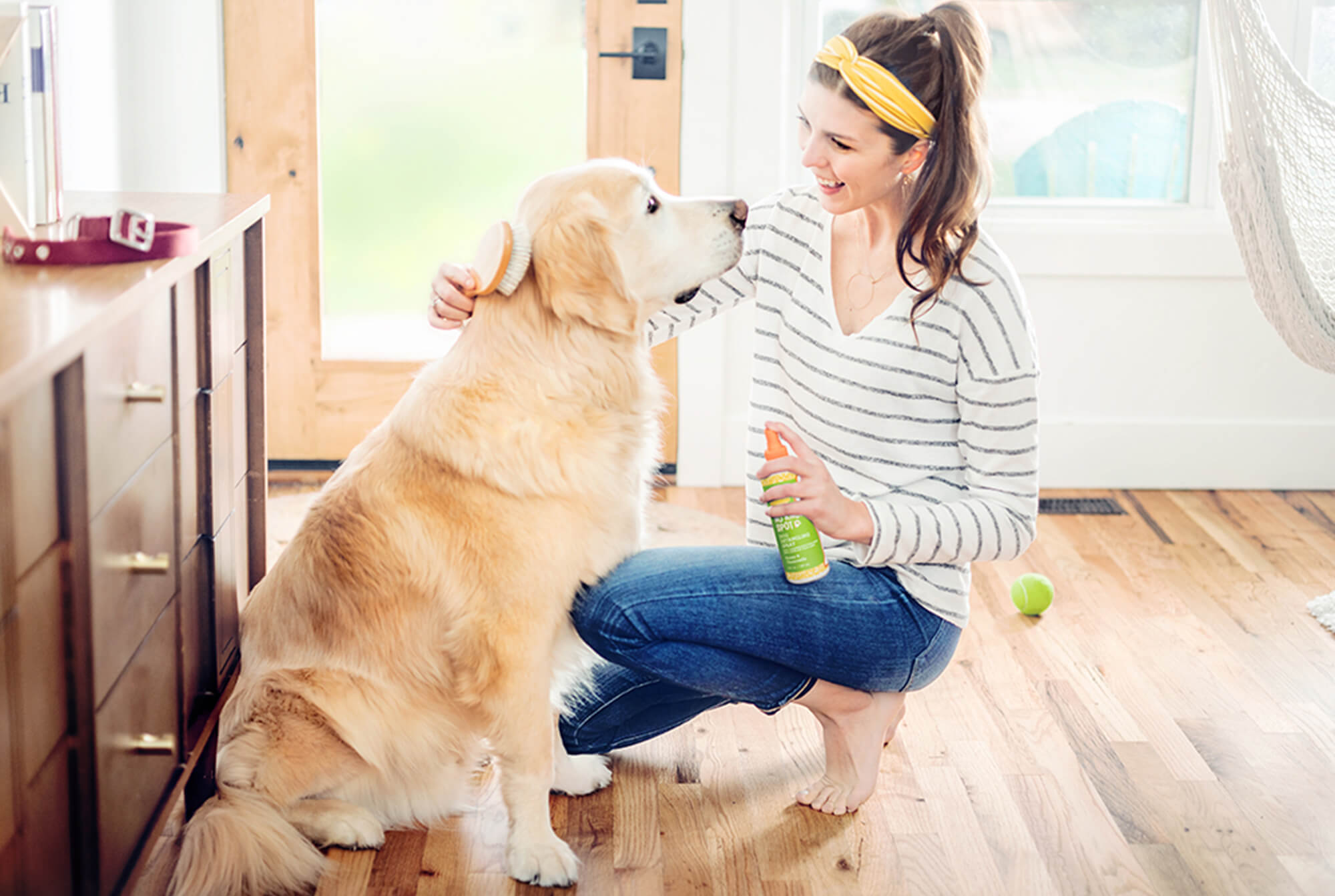 Woman using Oatmeal & Aloe Scentsy Pets product on her golden retriever