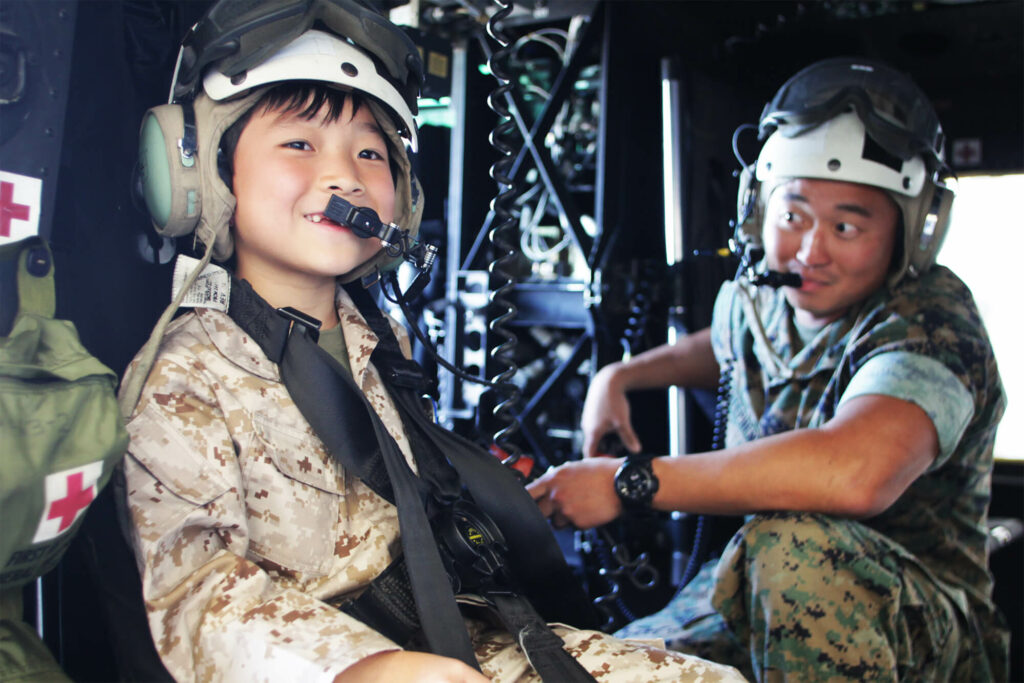 Make a wish child Haoran smiling from a helicopter
