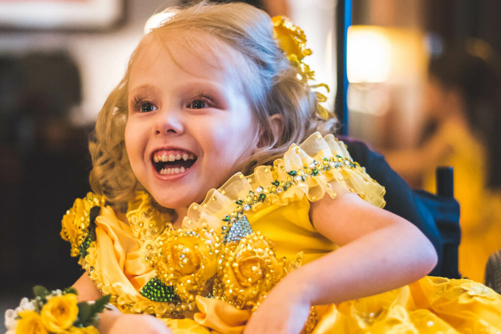 smiling Make a wish child Jessa in her yellow dress
