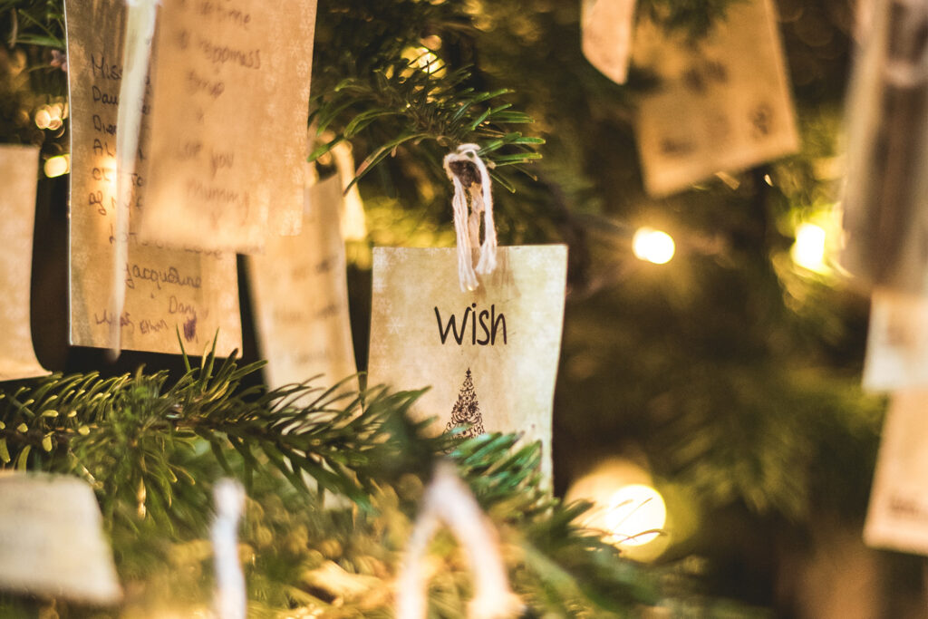 Christmas tree with wishes hanging on it