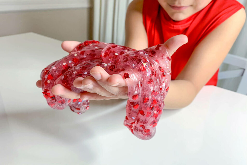 Kid playing with the finished Valentine's Day slime