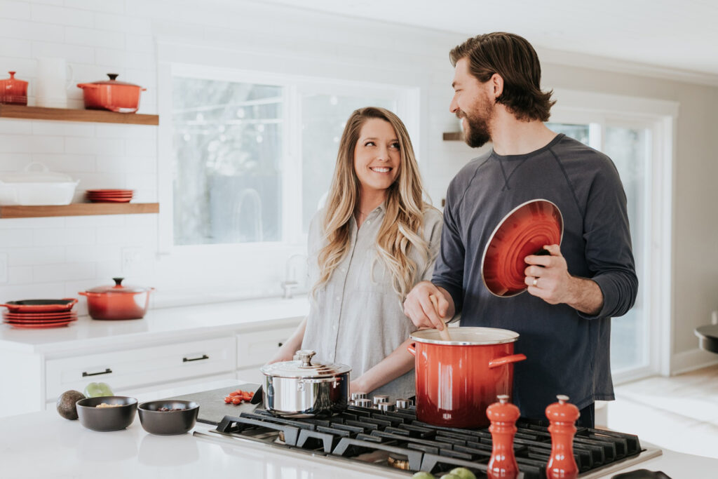 Couple in the kitchen cooking and smiling