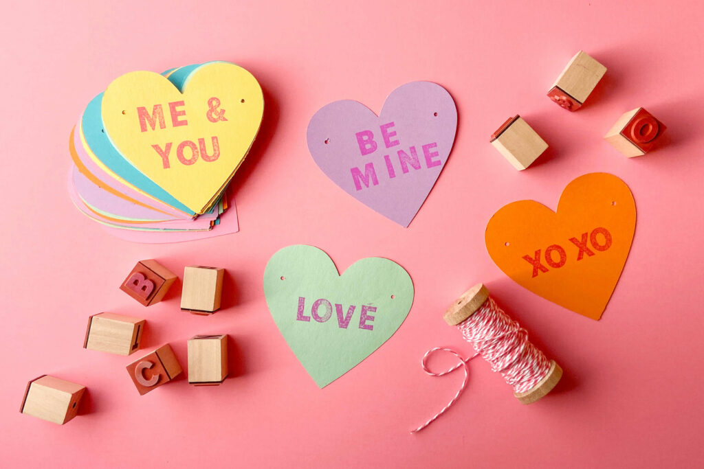 Stack of Candy Garland Hearts with supplies surrounding the stack