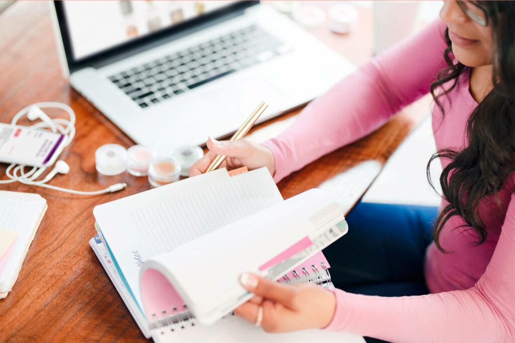 Woman writing in a planner to get organized for 2020