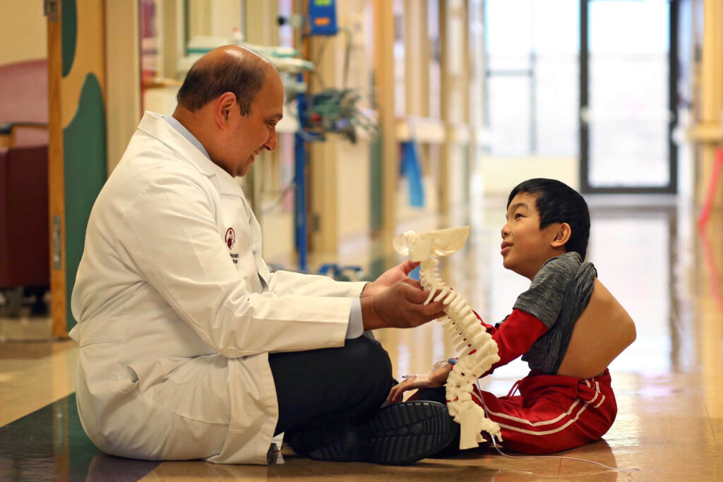 Child and doctor hanging out in hallway