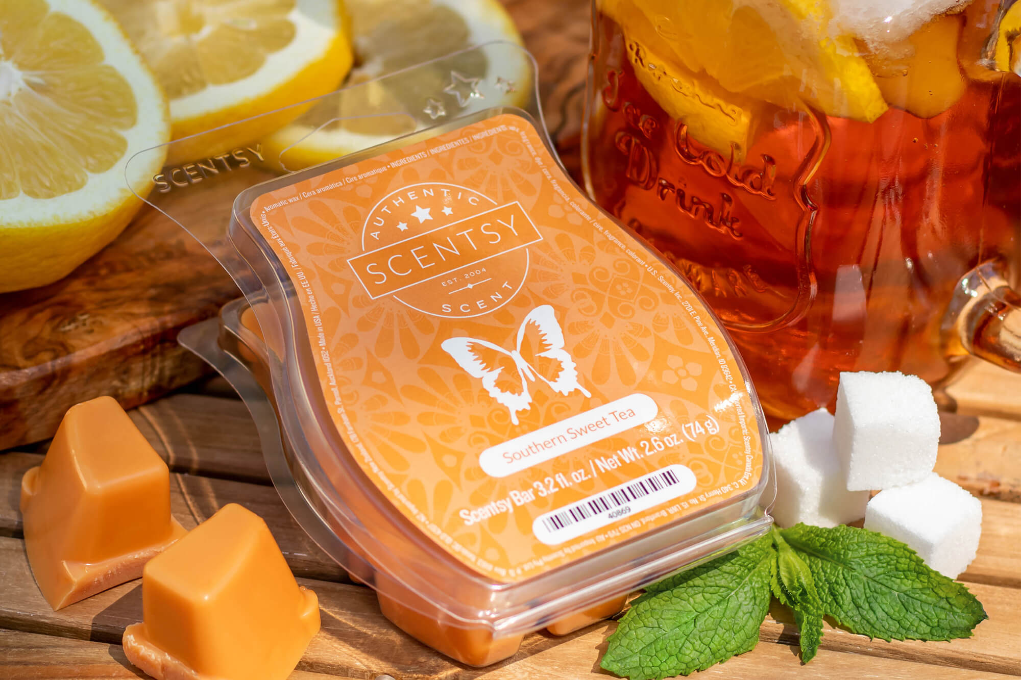 Scentsy Southern Sweet Tea wax bar surrounded by lemon, sweet tea, sugar cubes, and mint