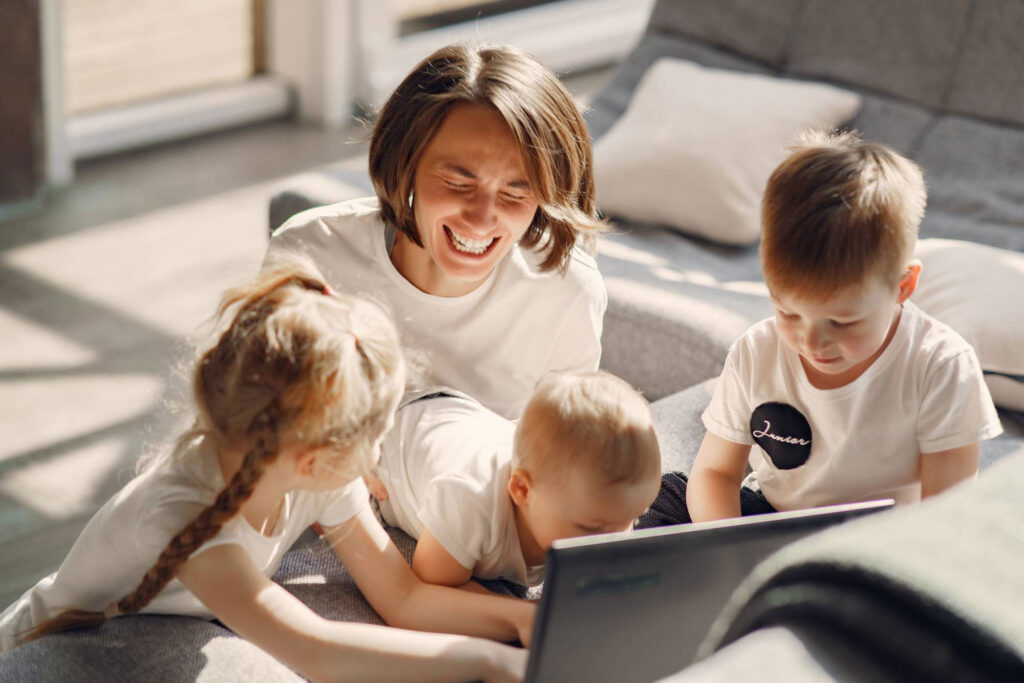 mom and kids playing on computer