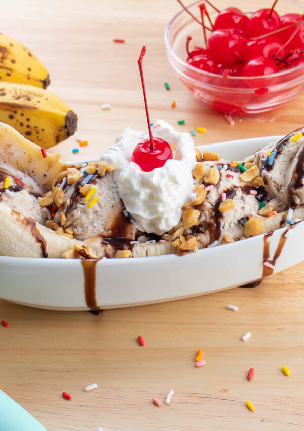 Banana split surrounded by the ingredients