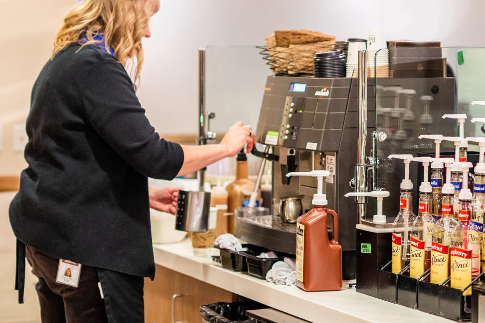 Scentsy Cafe - Person making coffee for a customer