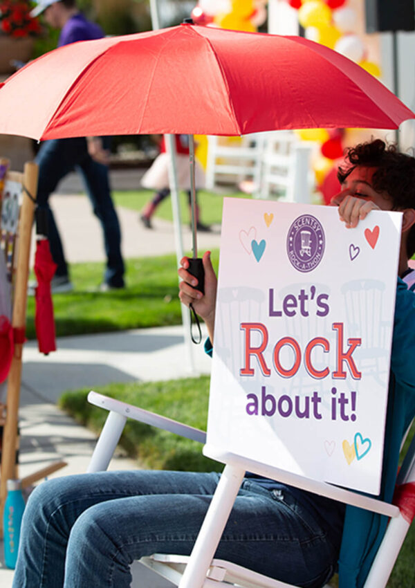 Scentsy Rock-a-Thon person rocking with a hand sign