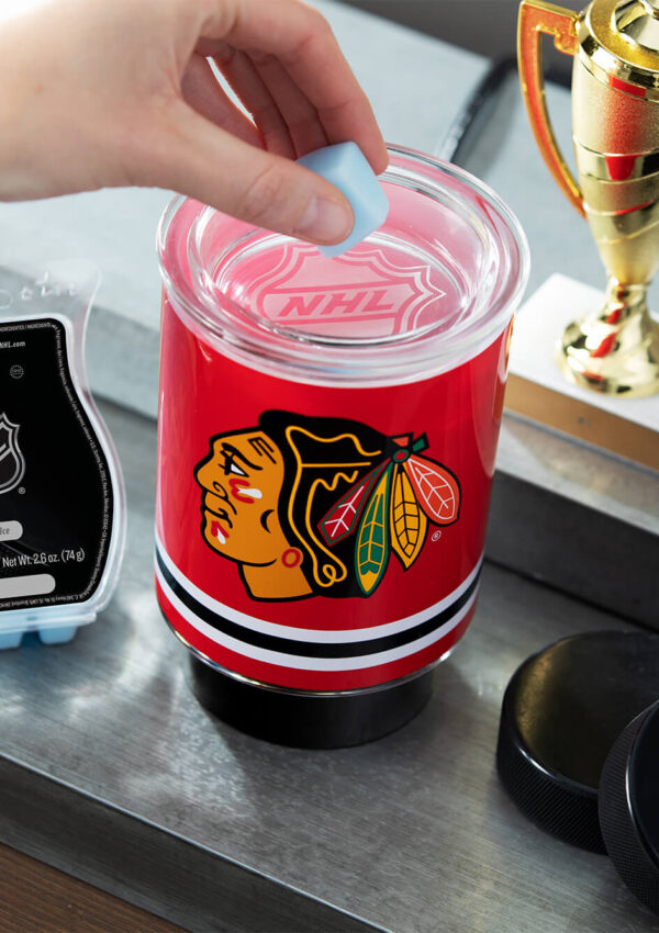 Scentsy NHL Blackhawks mini warmer with Fresh Ice wax with a trophy and hockey pucks nearby