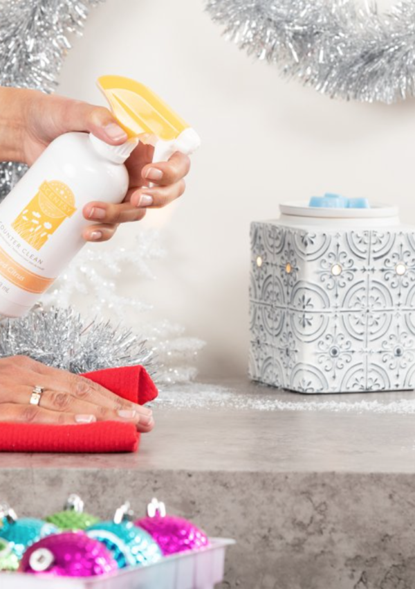 Person cleaning off counter with Scentsy Counter Cleaner