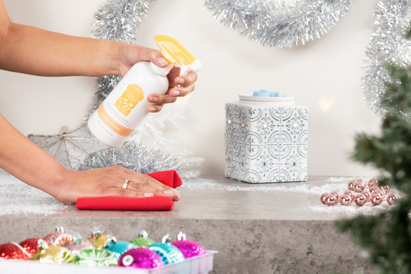 Person cleaning off counter with Scentsy Counter Cleaner