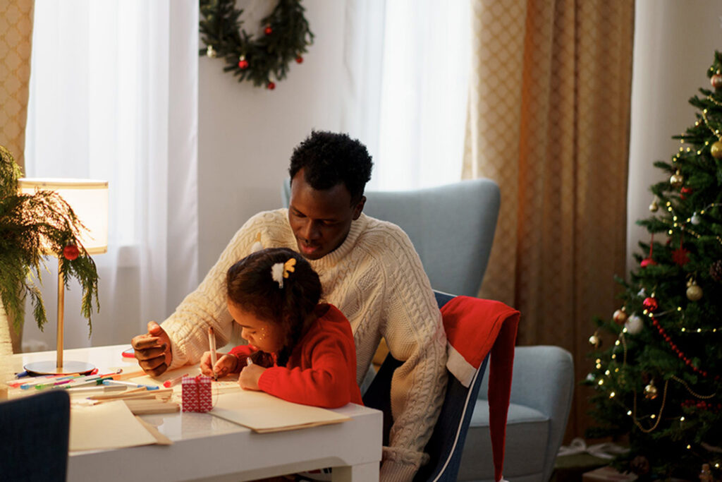 Father and daughter making crafts at a desk