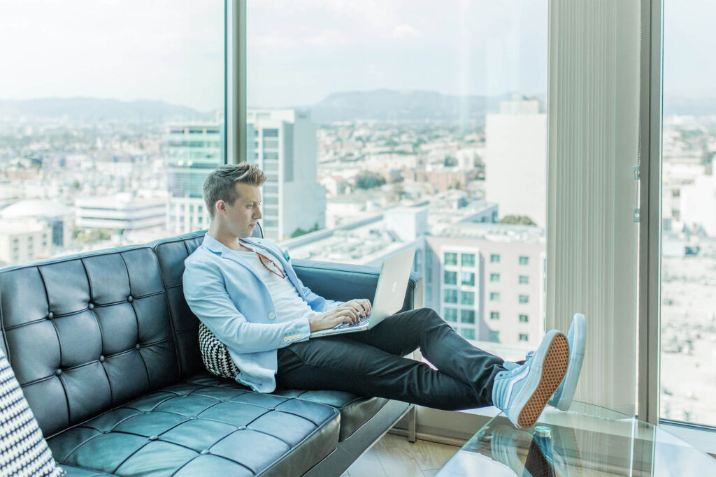 Person dressed up sitting on their couch doing work