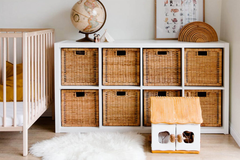 Organized cabinets next to a crib with decorations on top