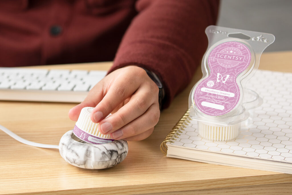 Person placing Cloudberry Dreams Scentsy Pod into a Marble Mini Diffuser