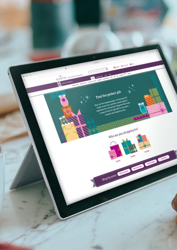 Scentsy homepage pulled up on an iPad while a person looks at the screen with a mug of hot cocoa in their hand