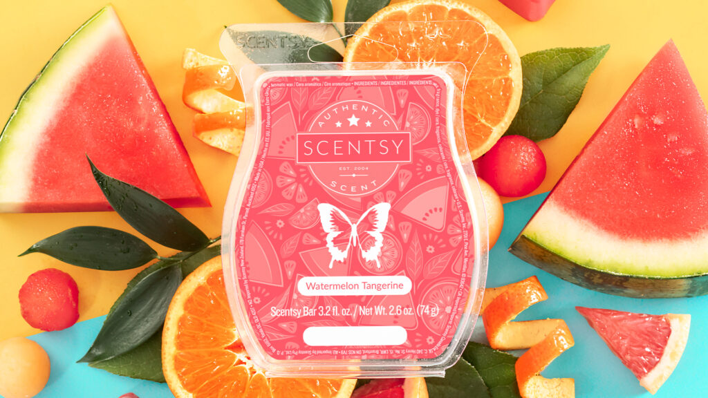 A Scentsy Watermelon Tangerine Wax Bar with red labled clamshell sits on a background of sliced watermelon and tangerine fruits.