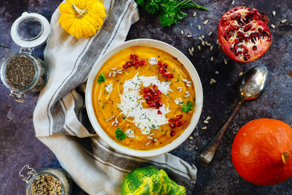 Butternut Squash Soup topped with pomegranate seeds, sunflower seeds and cream