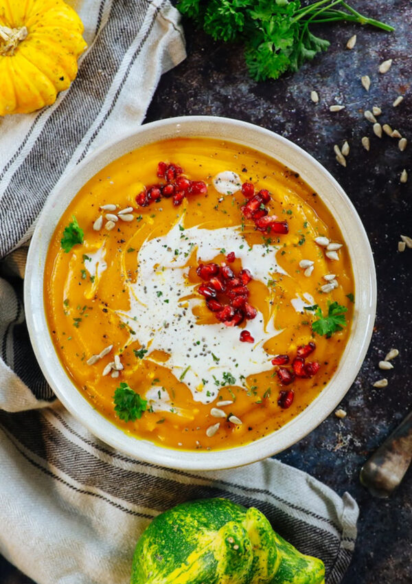 Butternut Squash Soup topped with pomegranate seeds, sunflower seeds and cream