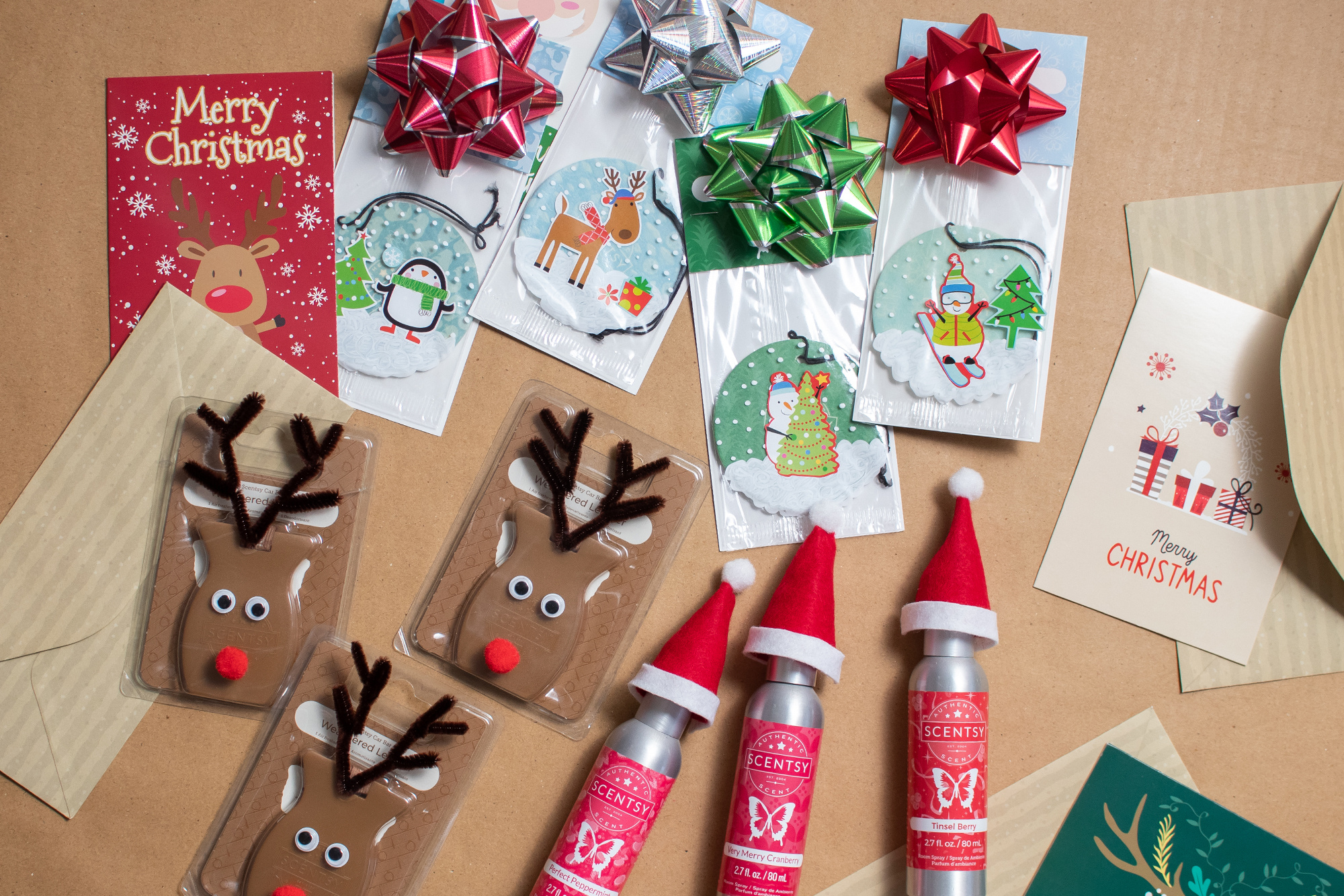 Gifts from Scentsy for the holiday season including room spray, car bars, and scent circles all wrapped in festive décor and ready to gift along with homemade Christmas cards