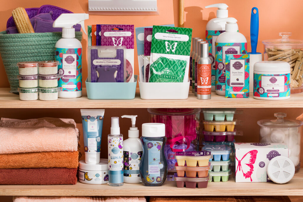 Variety of Scentsy products on shelves in many different scents including body and laundry products, wax melts, room spray, car bars and scent pods, circles and paks!