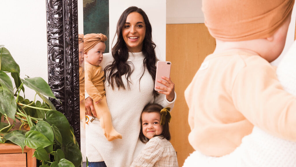 A mother taking a selfie photo in a mirror with her two children on mothers day!