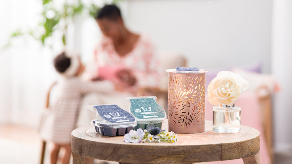Products from Scentsy's Mother's Day Collection! Pictured is the Golden Glow wax warmer, Buttercup Belle Fragrance Flower scented with Blue coconut beach and wax bars Blue Coconut Beach and Wildflower Cotton fragrances